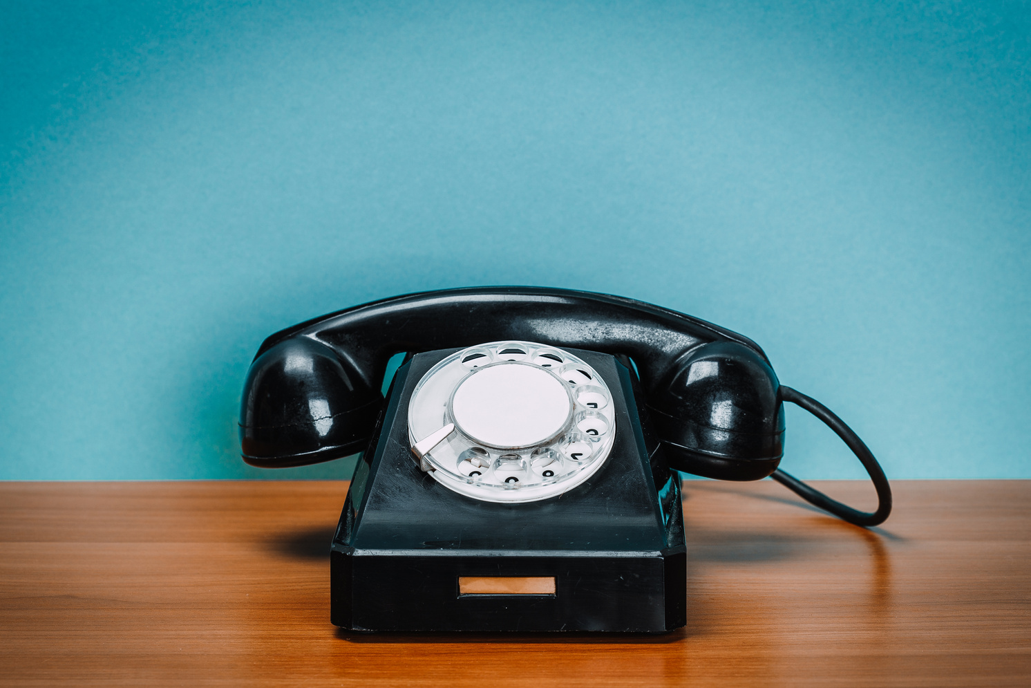 Old phone on wooden table